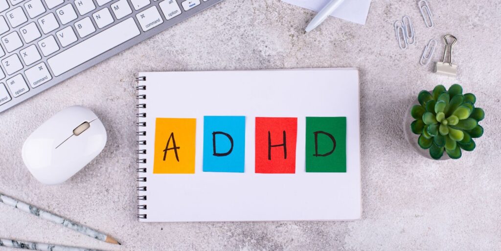 Organized workspace with ADHD planner and digital tools, illustrating support from AI tools for neurodivergent users