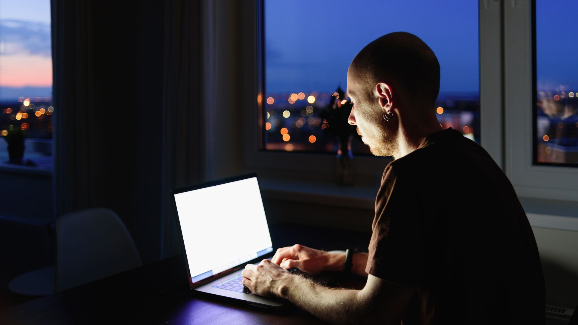 Small business owner at a laptop checking AI tool costs against the time they save